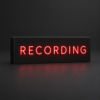 Black resin recording sign with thin red illuminated lettering